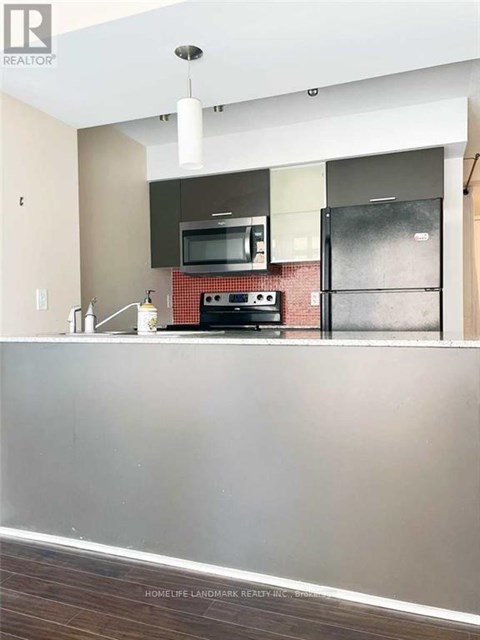 A kitchen with a stove top oven and microwave.