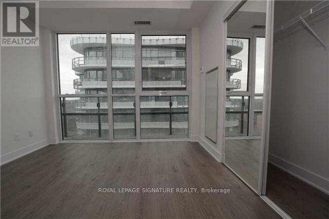 A room with a view of a building outside the window.