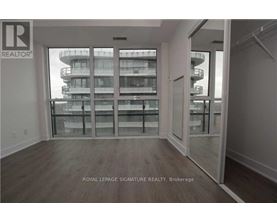 A room with a view of a building outside the window.