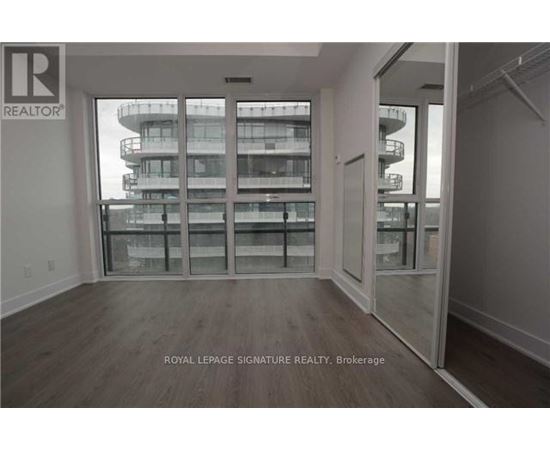 A room with a view of a building outside the window.