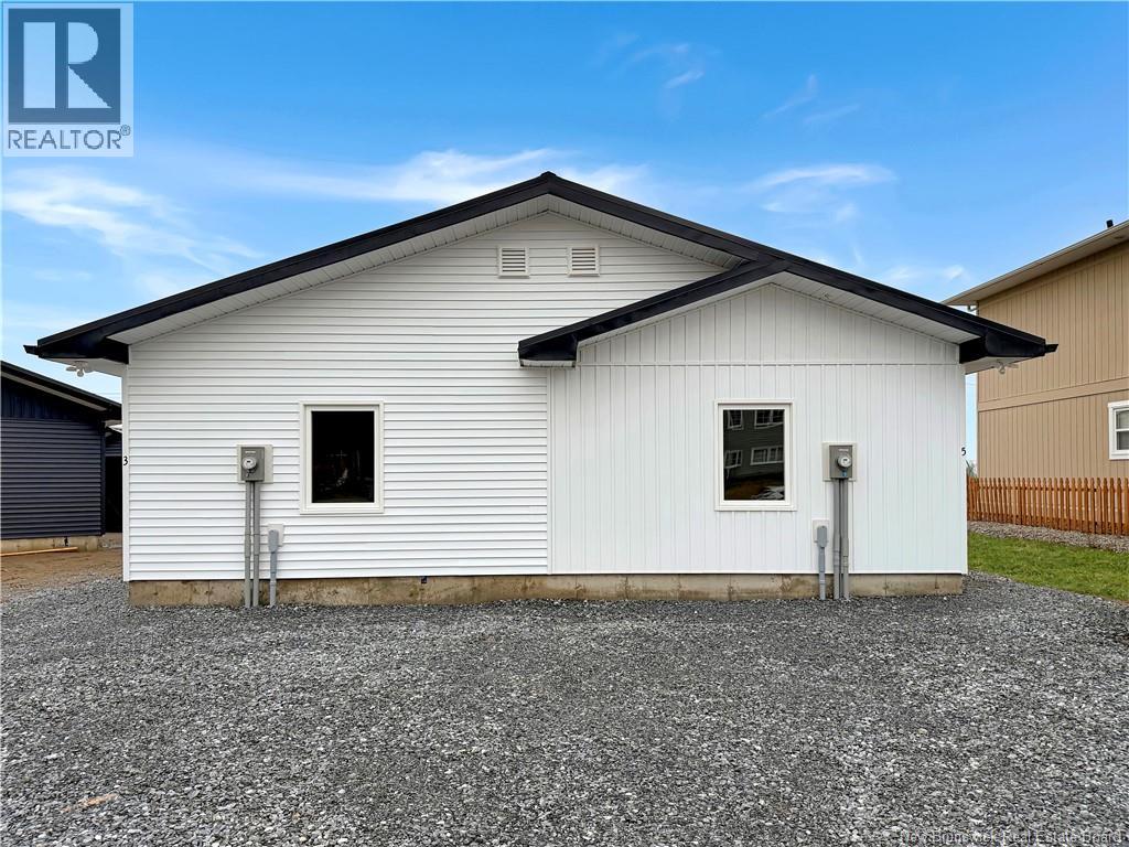 A white house with a wooden door and a small porch.