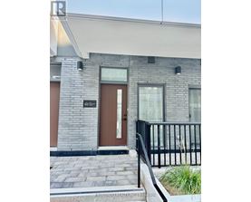 A modern house with a brown door and windows.
