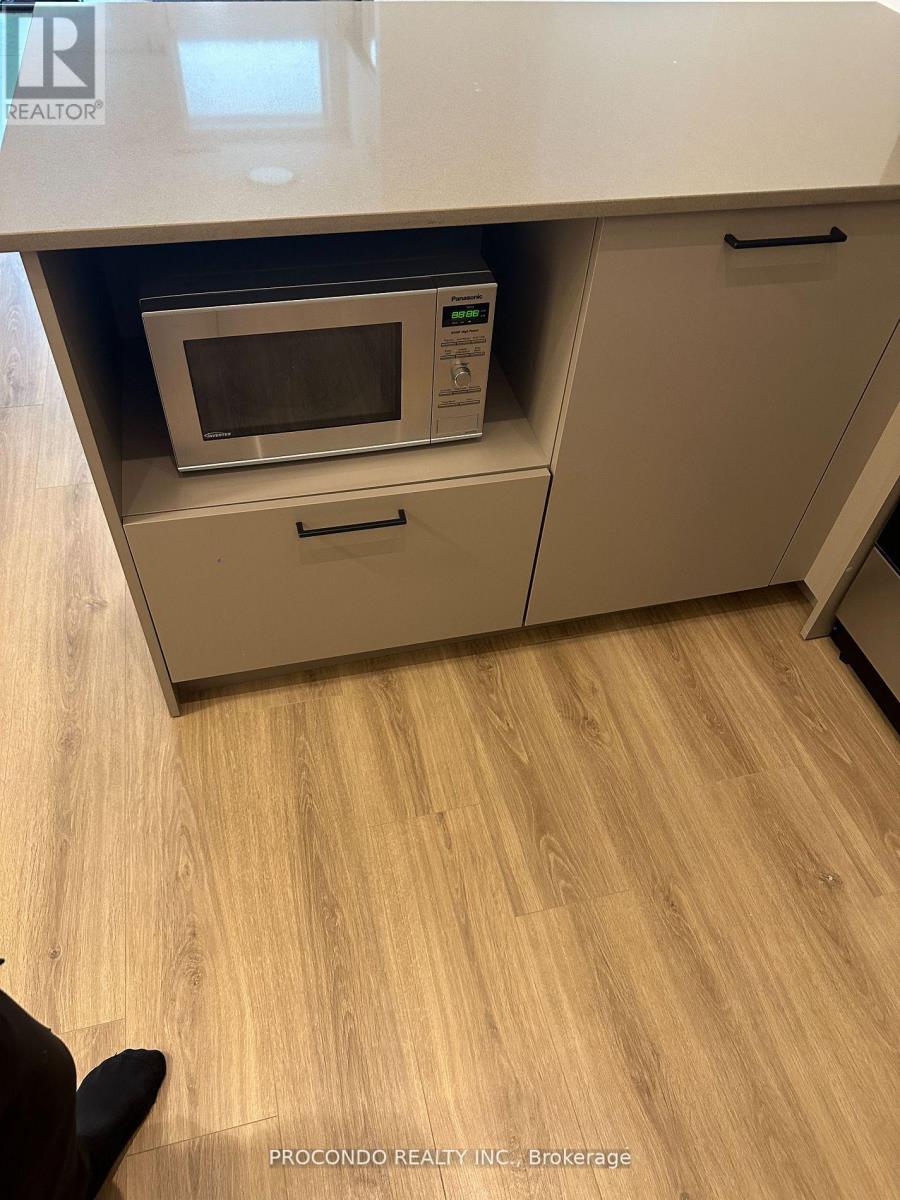 A kitchen with a microwave oven in a drawer.