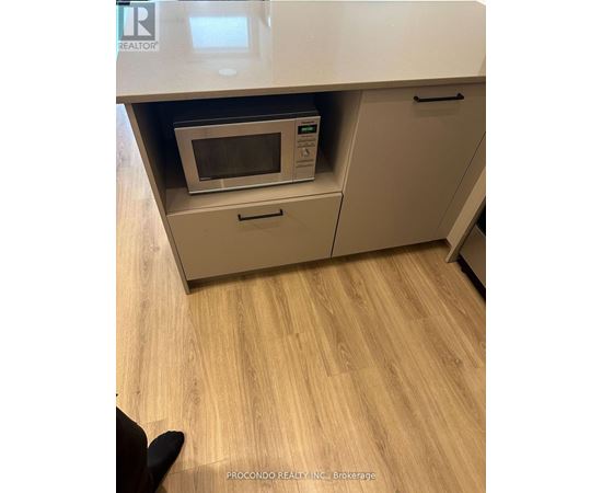 A kitchen with a microwave oven in a drawer.