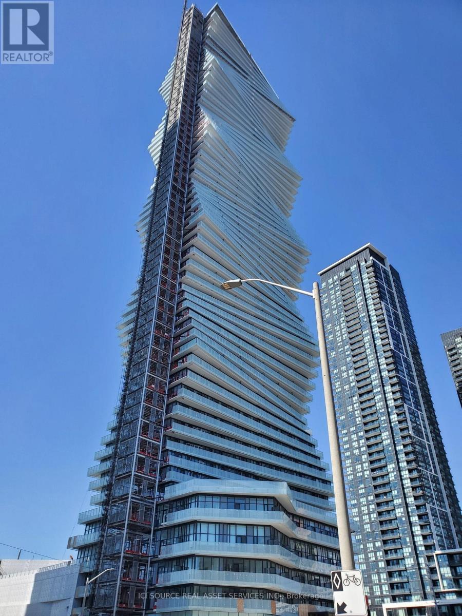 A tall building under construction with a crane in the foreground.