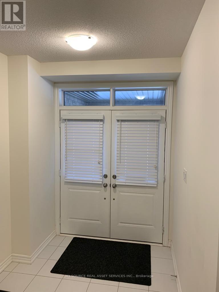 A white door with a black mat in front of it.