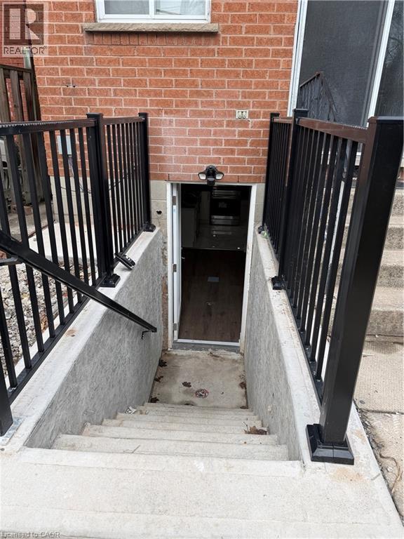 A black gate is on the side of a staircase.