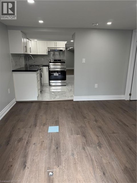 A kitchen with a white oven and a white fridge.