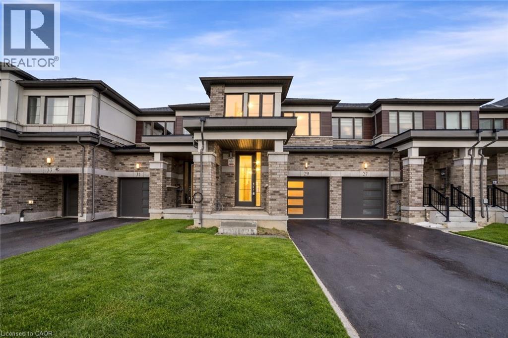 A large, modern house with a stone facade and a central entrance.