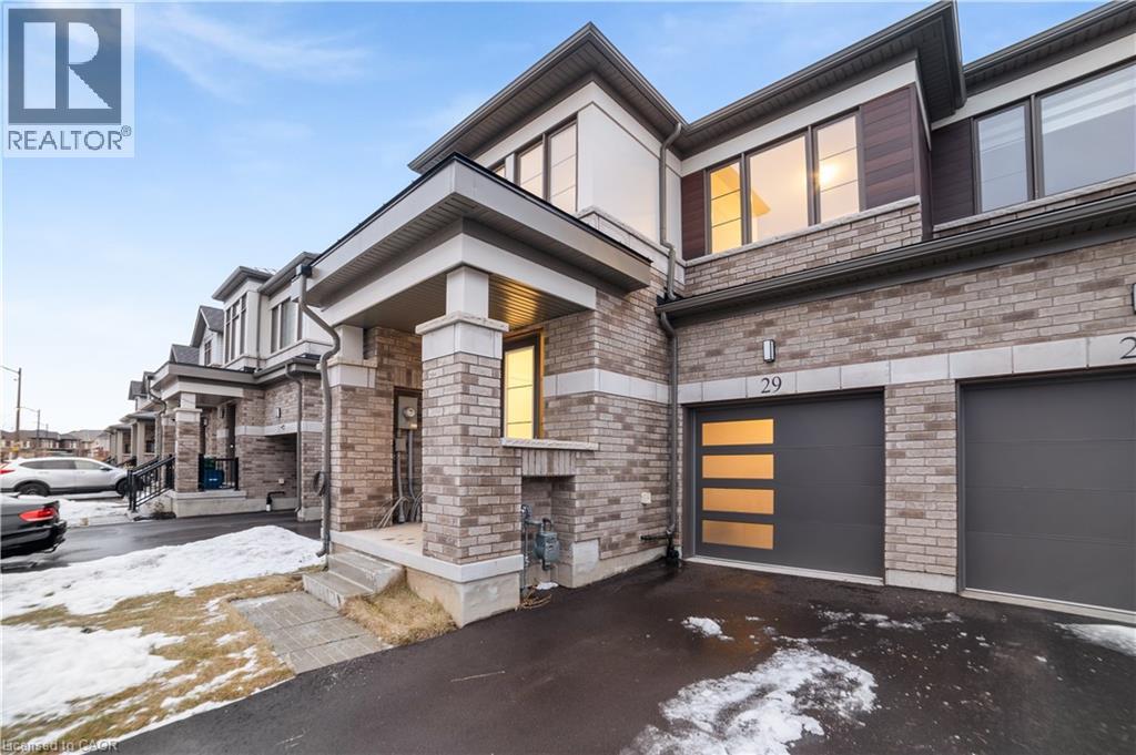 A modern house with a garage is for sale.