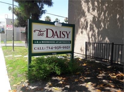 A sign for The Daisy 1 and 2 bedroom apartments.