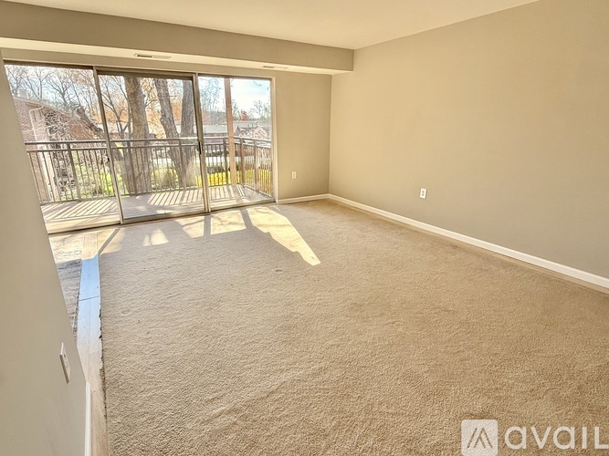 A kitchen with white cabinets and a wooden floor.