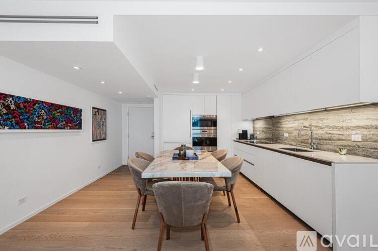 A modern kitchen with a dining table set up.