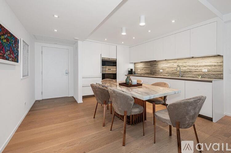 A dining room with a wooden table and chairs.