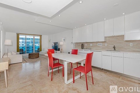 A kitchen with a table and chairs in the middle of the room.