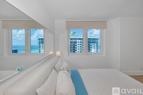 A bedroom with a large bed and a view of the city.