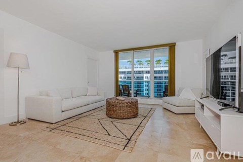 A living room with a large window overlooking a cityscape.