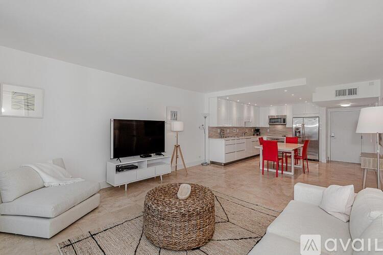A living room with a white couch and a television.