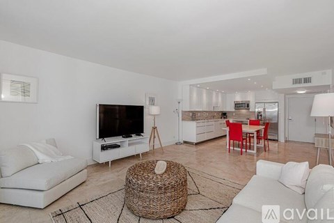 A living room with a white couch and a television.