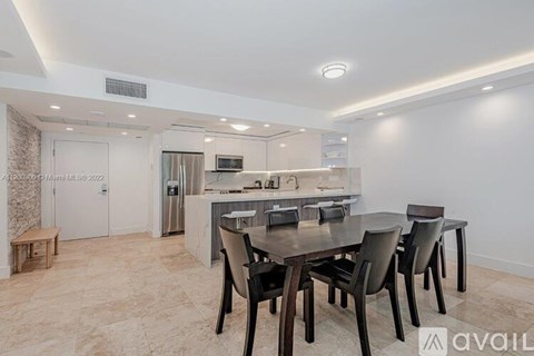 A modern kitchen with a dining table and chairs.