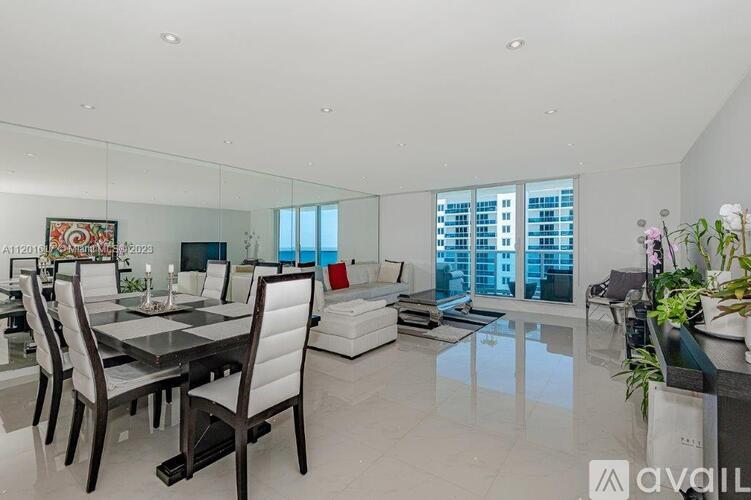 A modern dining room with a glass table and chairs.