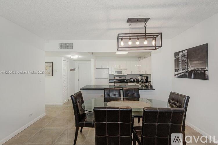 A dining room with a table and chairs.