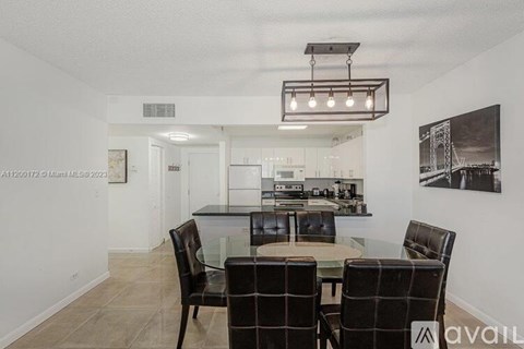 A dining room with a table and chairs.