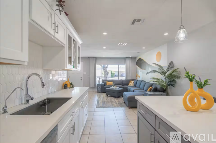 A modern kitchen with white cabinets and a large island.