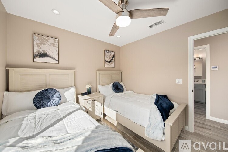 A bedroom with a large bed and a smaller bed in the corner.
