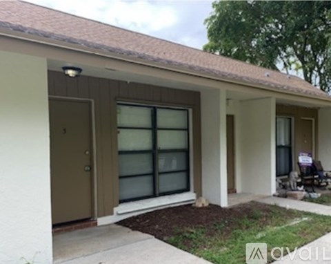 A house with a brown door and glass windows is for sale.