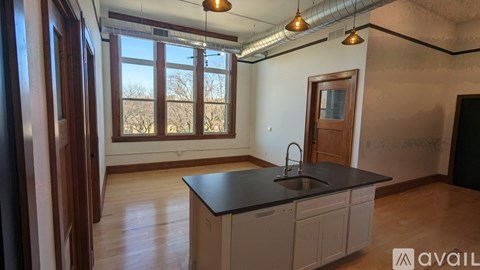 A kitchen with a sink and a window.