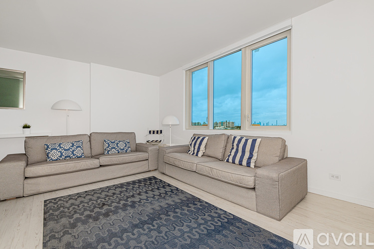 A living room with two couches and a rug.