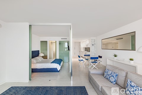 A bedroom with a bed and a couch in a room.