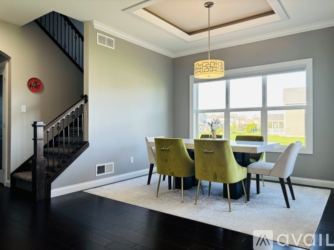 A dining room with a table and chairs.