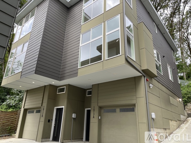 A modern house with a grey and beige exterior.