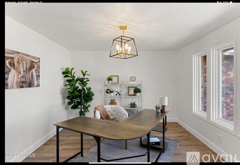 A living room with a brown table and a plant on the shelf.