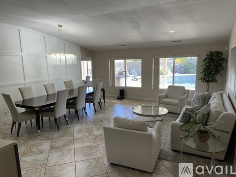A living room with a dining table and chairs.