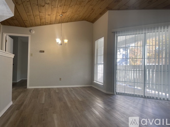 A room with wooden floors and a ceiling with wooden beams.