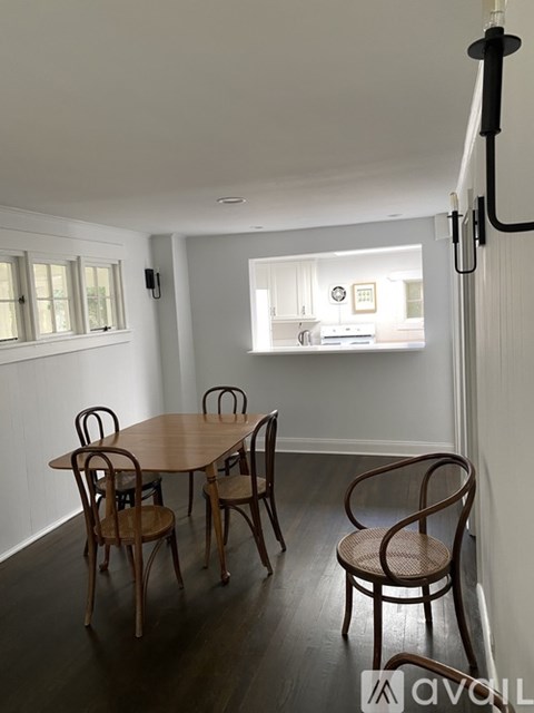 A dining room with a table and chairs.