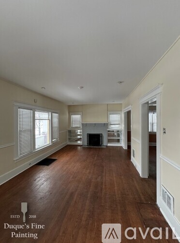 A room with wood floors and white walls.