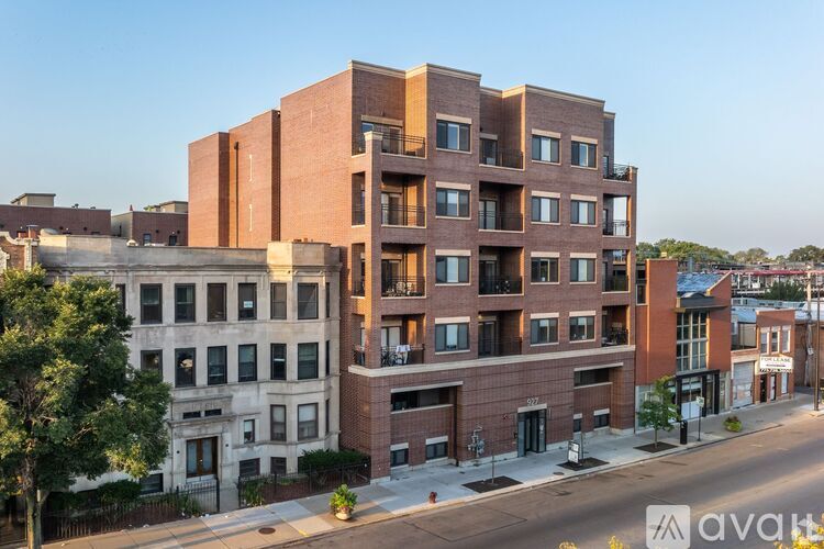 A modern brick building is situated on a street corner.