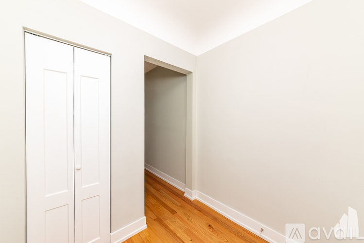 A white door is on the left and a white wall is on the right.