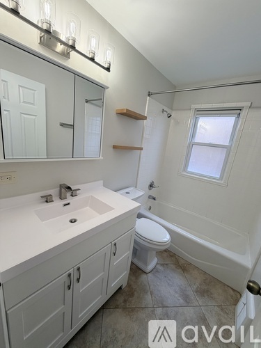 A bathroom with a white toilet and a white sink.