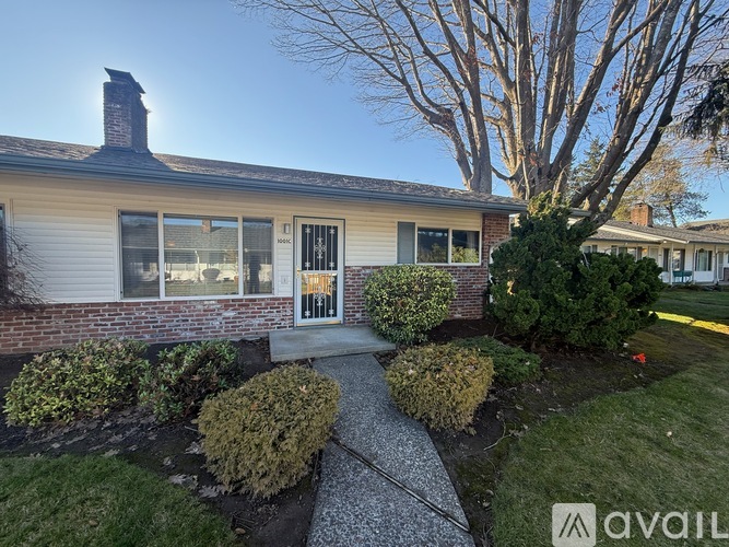 A house with a front yard and a pathway leading to the front door.