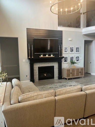 A living room with a fireplace and a television.