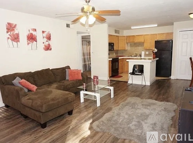 A living room with a brown couch and a white coffee table.