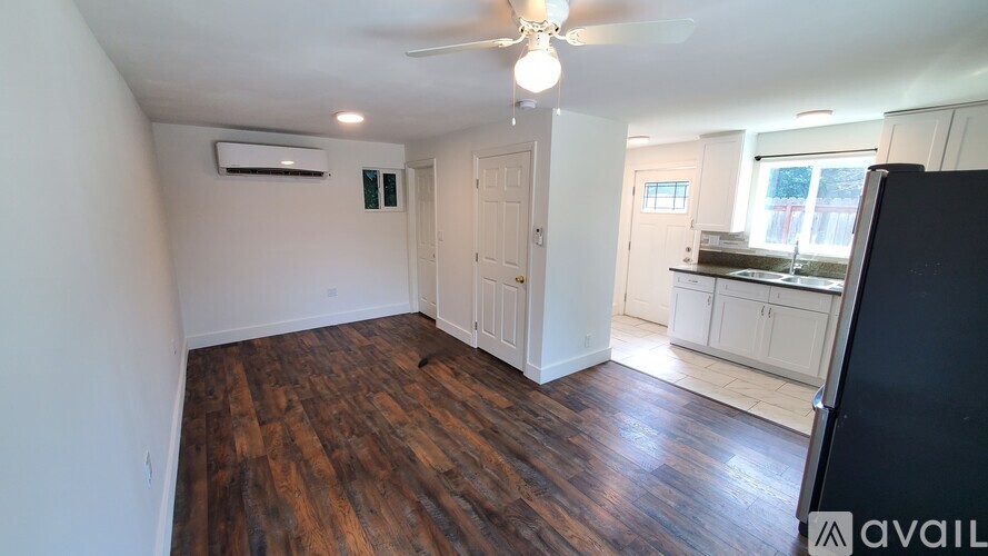 A room with wooden floors and a ceiling fan.