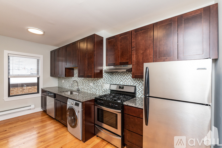 A kitchen with wooden cabinets and stainless steel appliances.