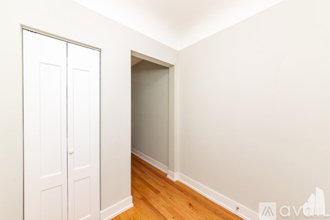 A white door is on the left and a white wall is on the right.