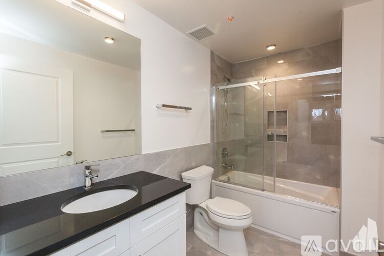 A bathroom with a sink, toilet, and bathtub.